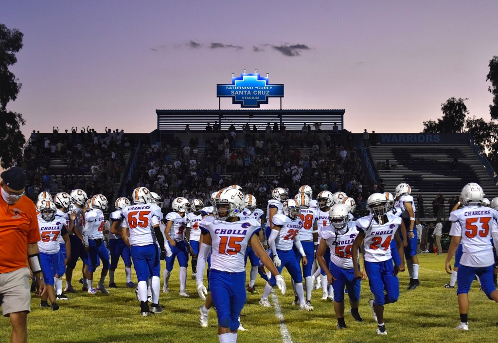 Cholla team football players walking off the field 