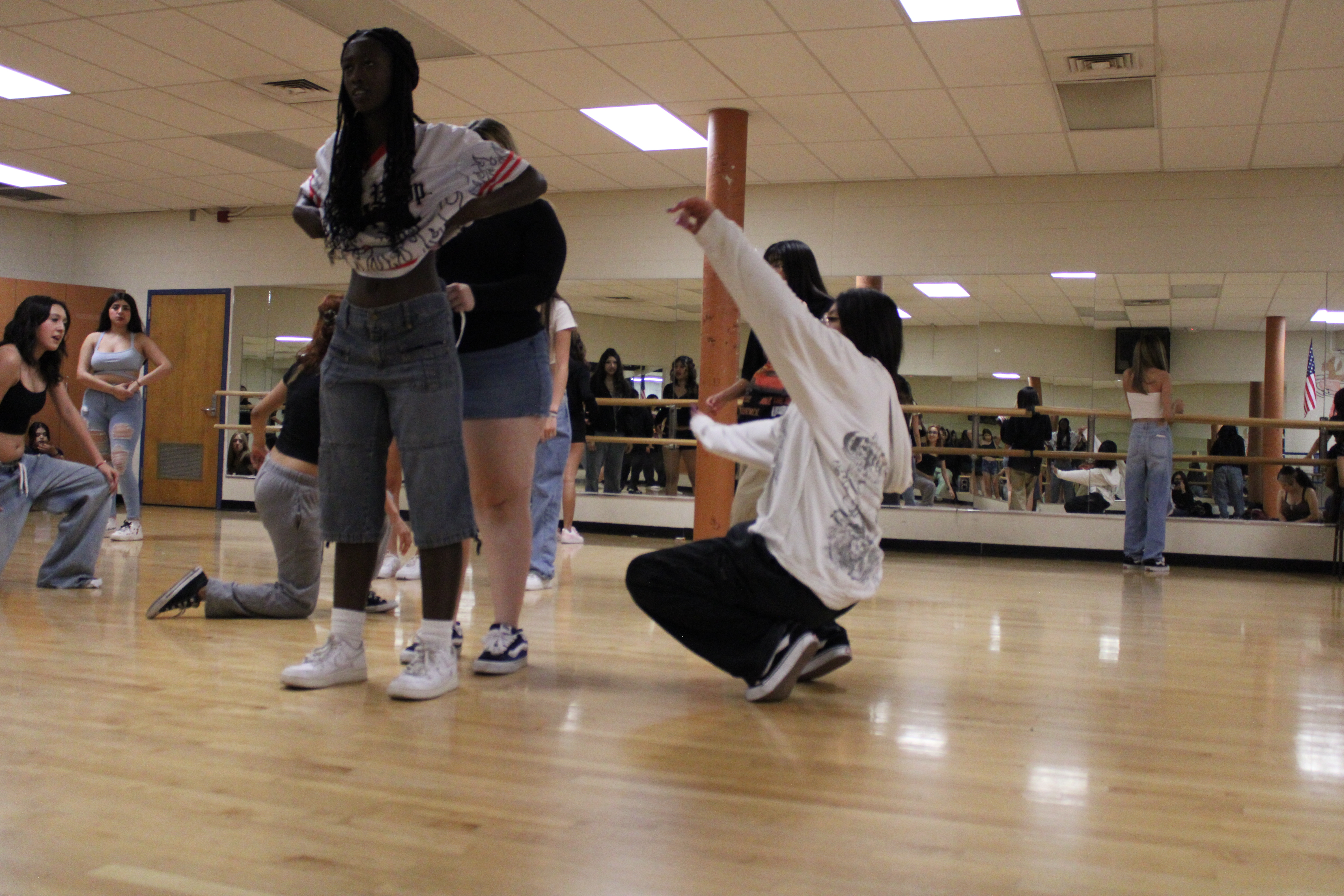 dancers Going over floor work learning new moves and the proper way to do them