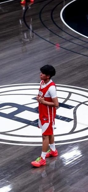 Kaylyn Miguel standing in the center of the basketball court.