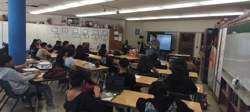 Picture displays Mr. Wiggins classroom working on art at their desks. 